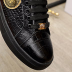 Black Versace sneakers close-up, textured upper with gold buckle and laces
