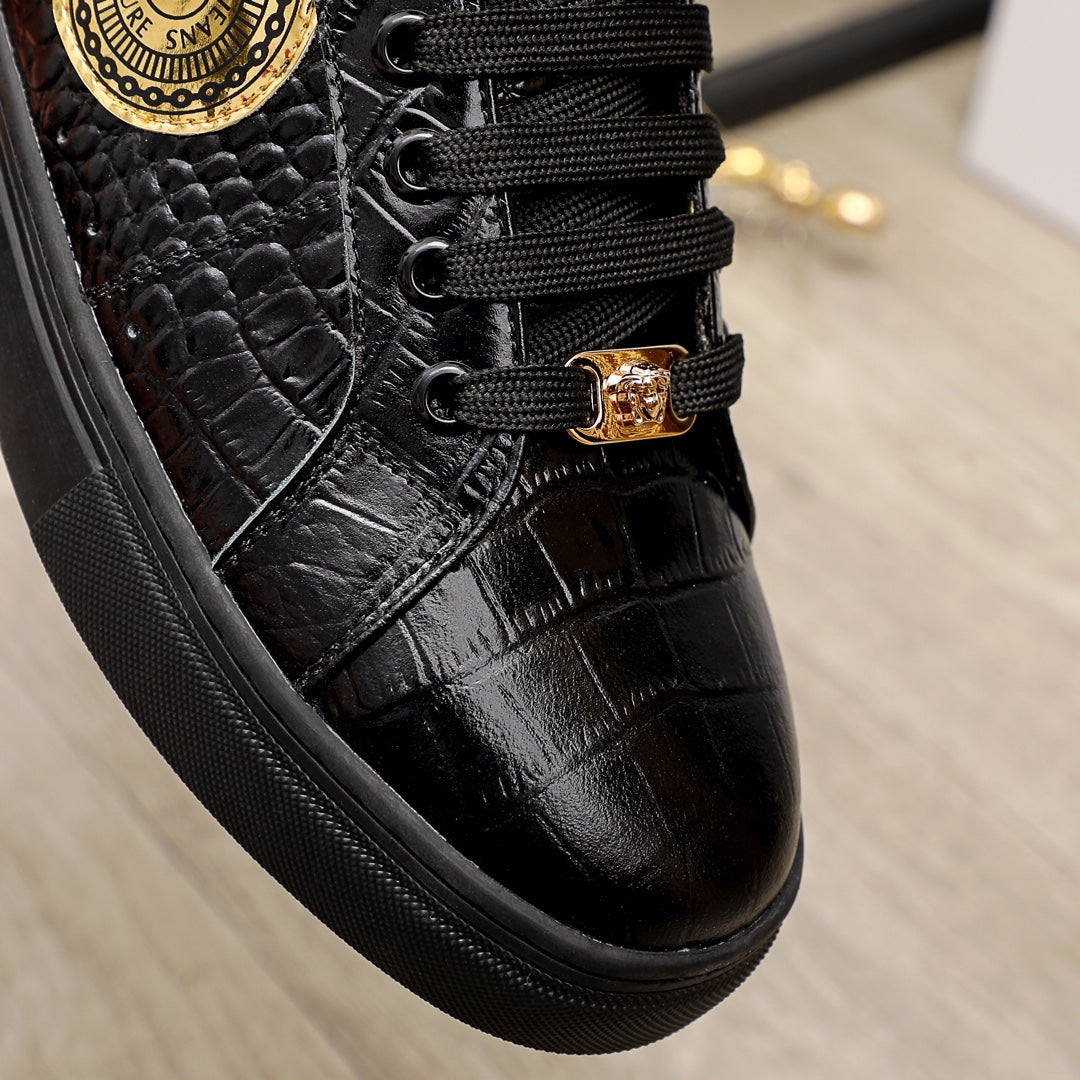 Black Versace sneakers close-up, textured upper with gold buckle and laces