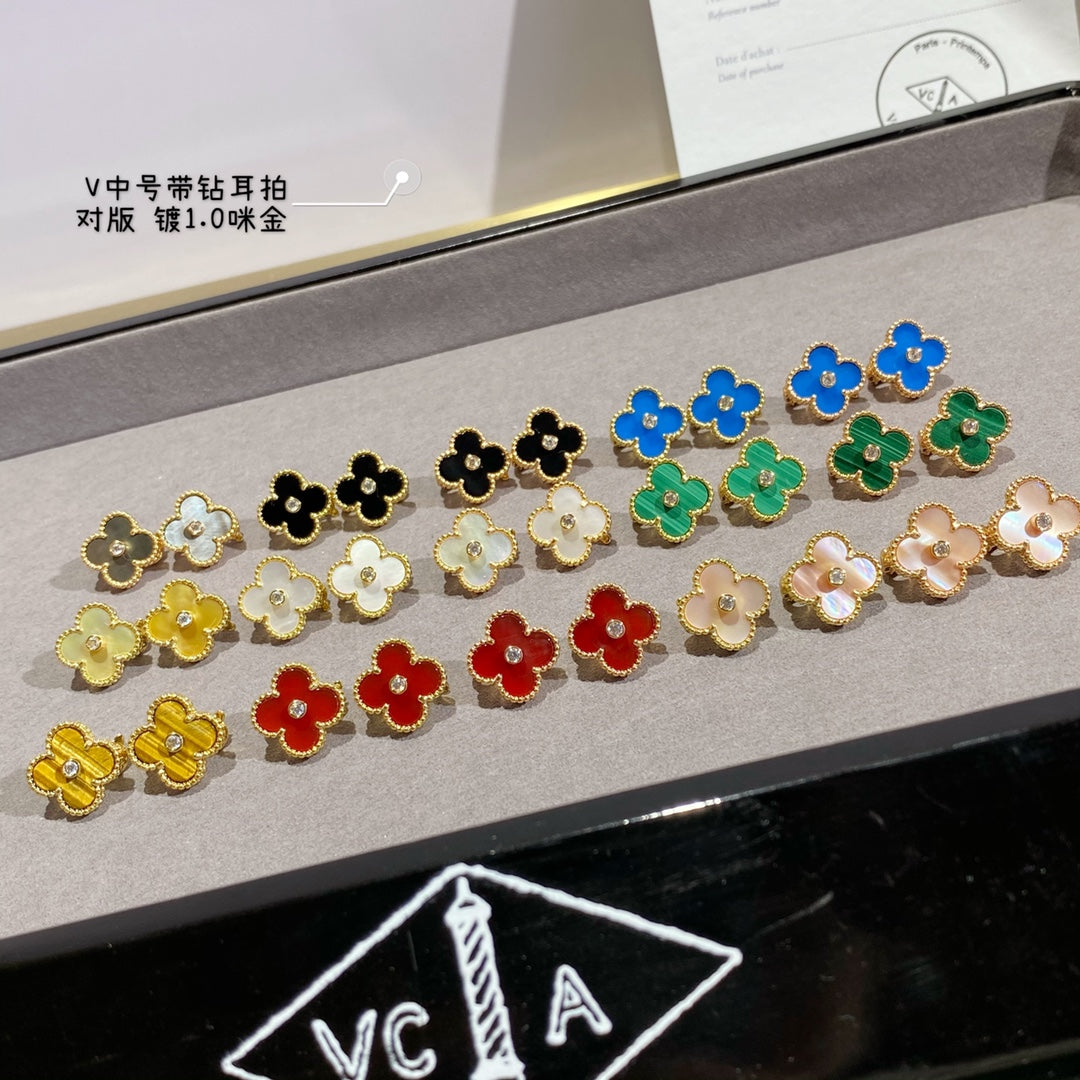 Clover-shaped stud earrings set with gold-tone outlines in black, white, blue, green, yellow