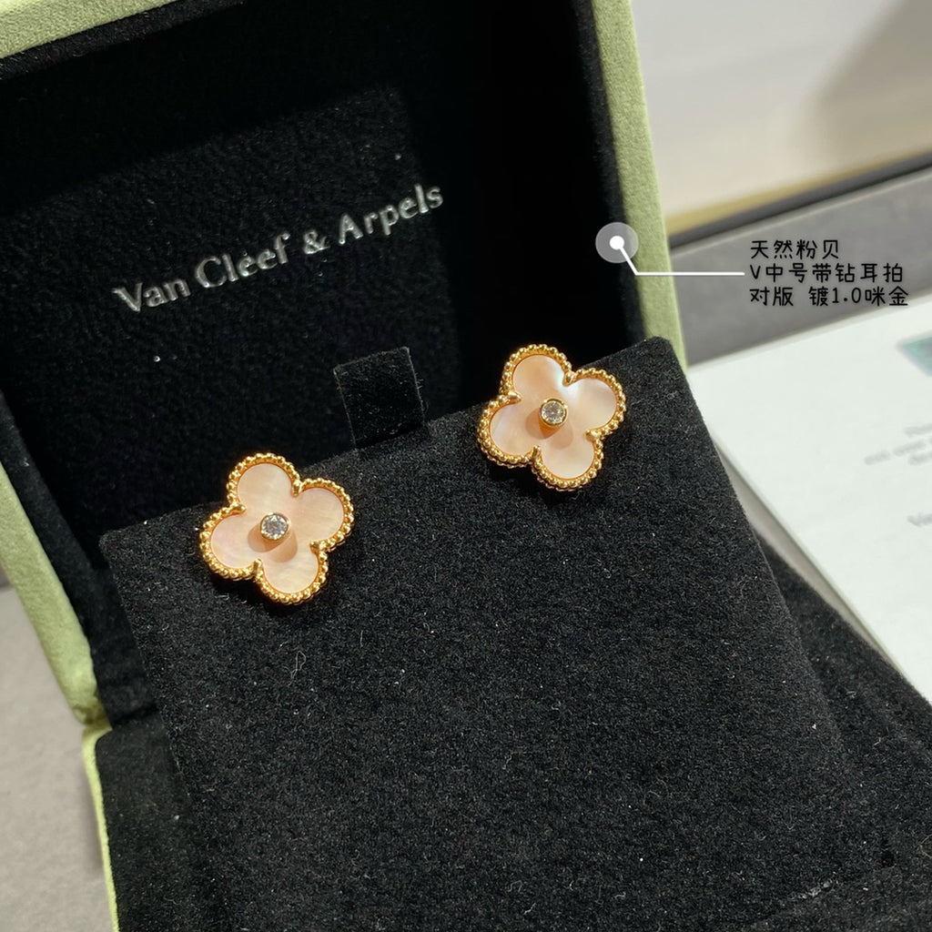 Gold clover stud earrings with white enamel petals and round clear center stone, pair