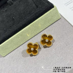 Gold clover stud earrings with yellow enamel and round crystal center