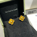 Gold clover stud earrings with yellow enamel and small round crystal in center