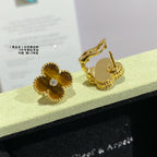 Gold clover stud earrings with yellow enamel, showing posts and front crystal detail