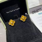 Gold clover stud earrings with yellow enamel and crystal center in presentation box