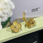 Gold clover stud earrings with clear stones, one shown with backing detail.