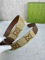 Gucci belt with beige GG canvas strap, dark brown leather ends, gold buckle