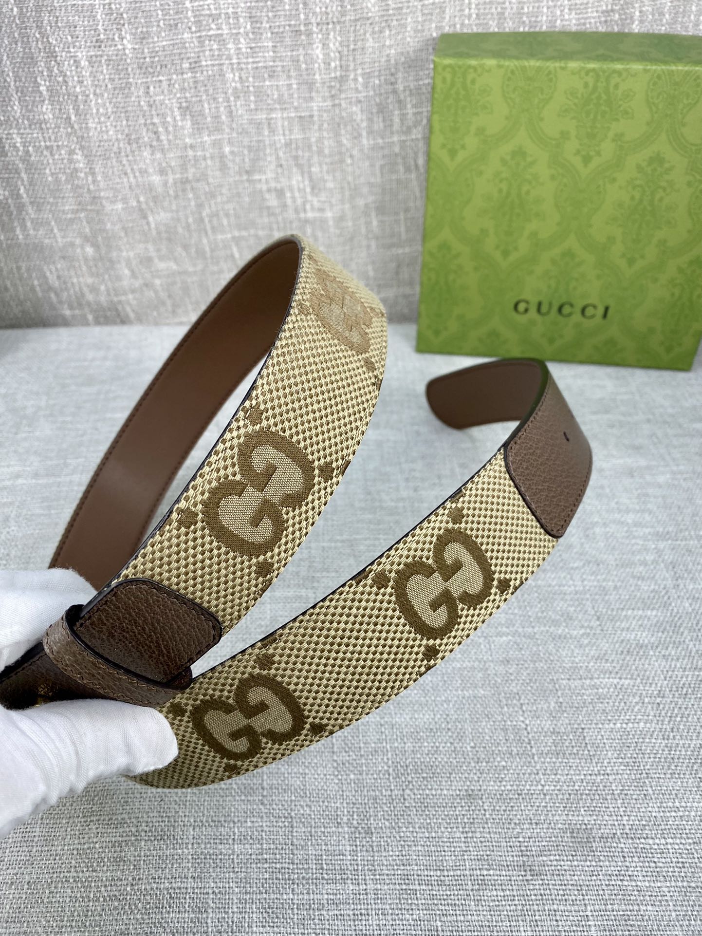 Gucci belt with beige GG canvas strap, dark brown leather ends, gold buckle