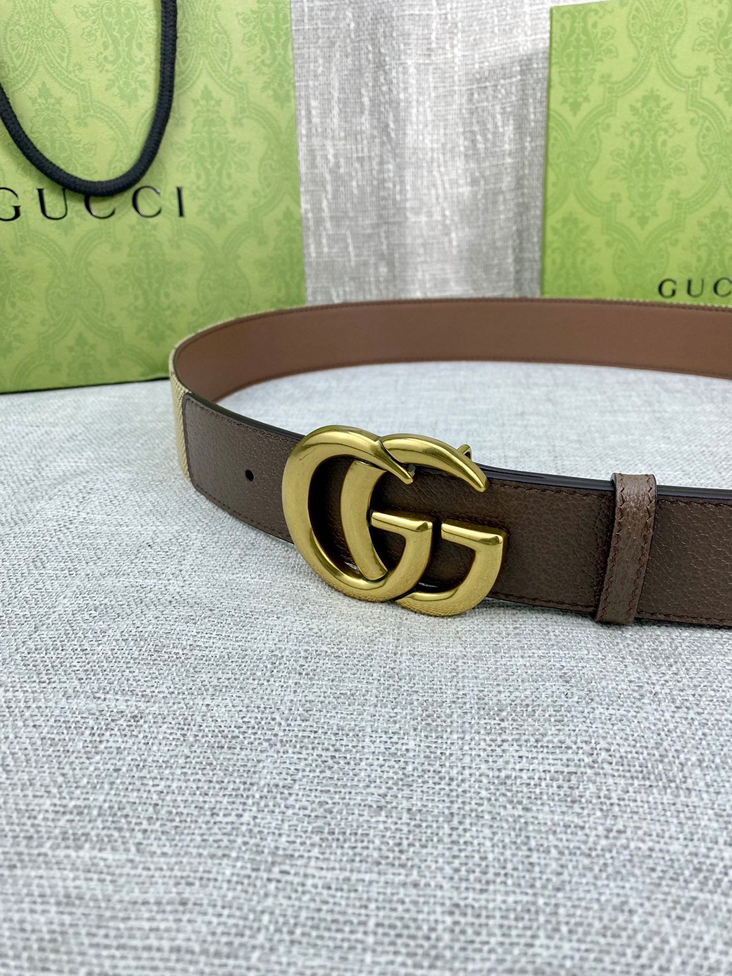 Gucci belt with dark brown leather strap and gold double-G buckle
