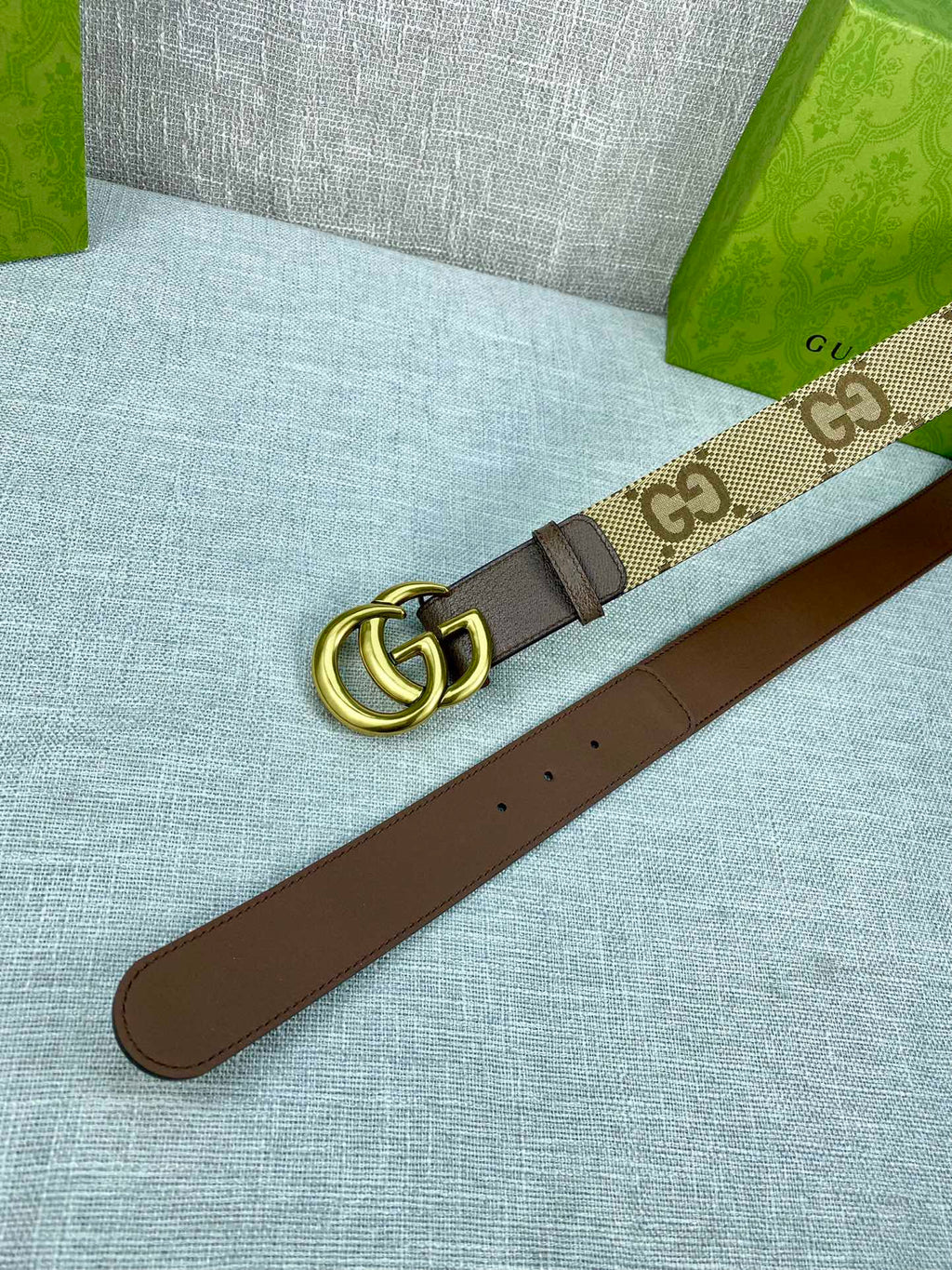 Gucci belt with beige GG canvas strap, gold buckle, dark brown leather underside