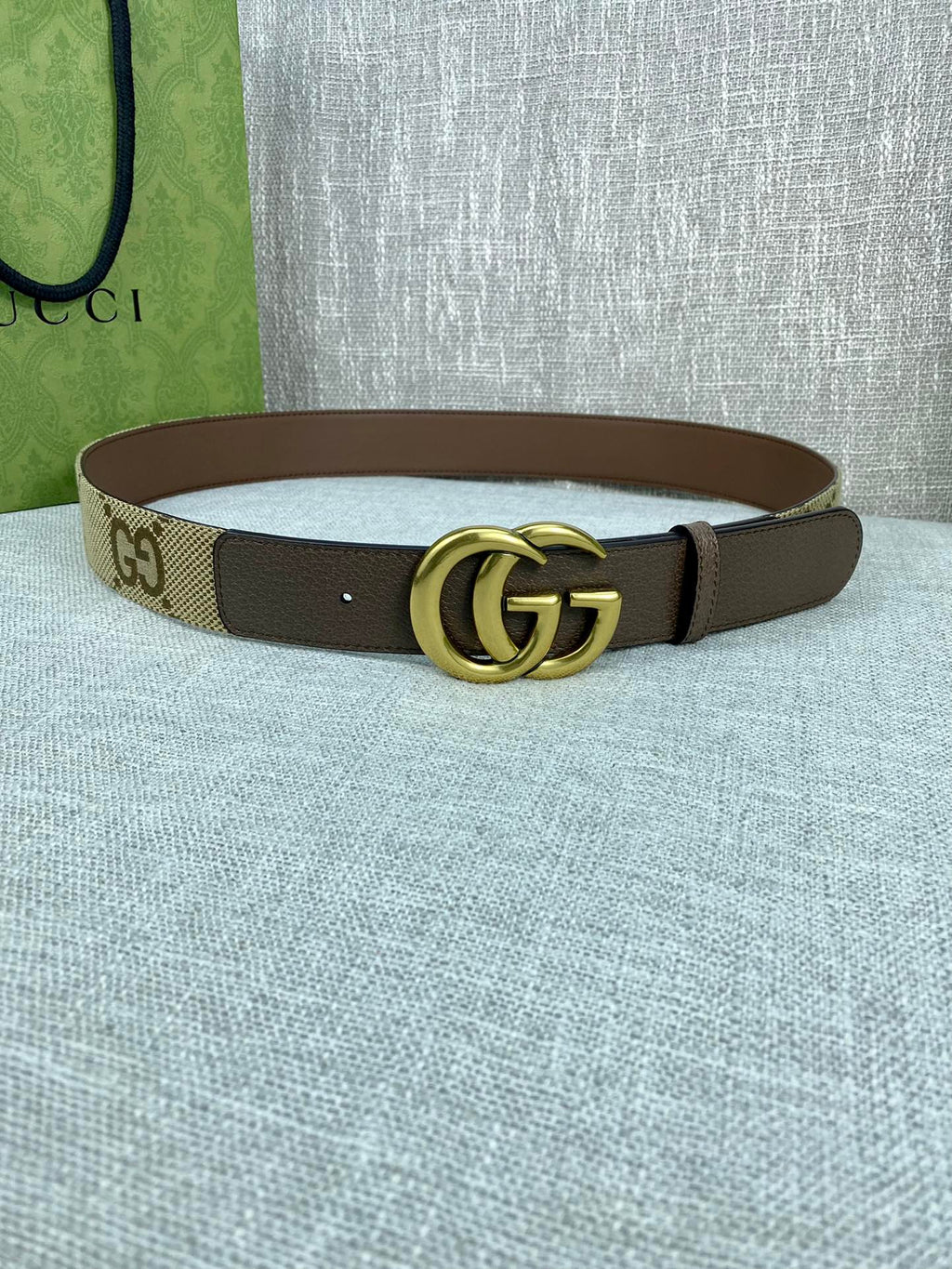Gucci belt with beige GG canvas strap, dark brown edges, gold double-G buckle