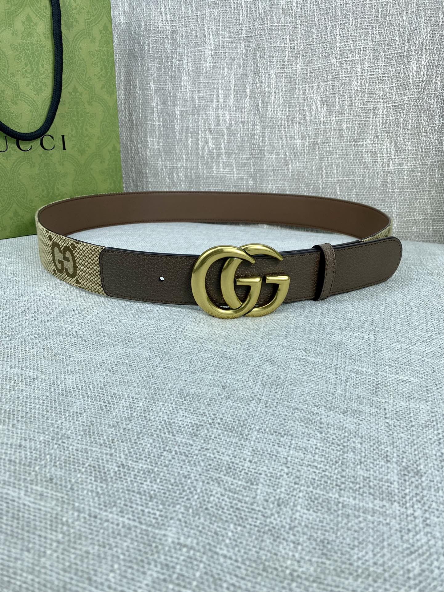 Gucci belt with beige GG canvas strap, dark brown edges, gold double-G buckle