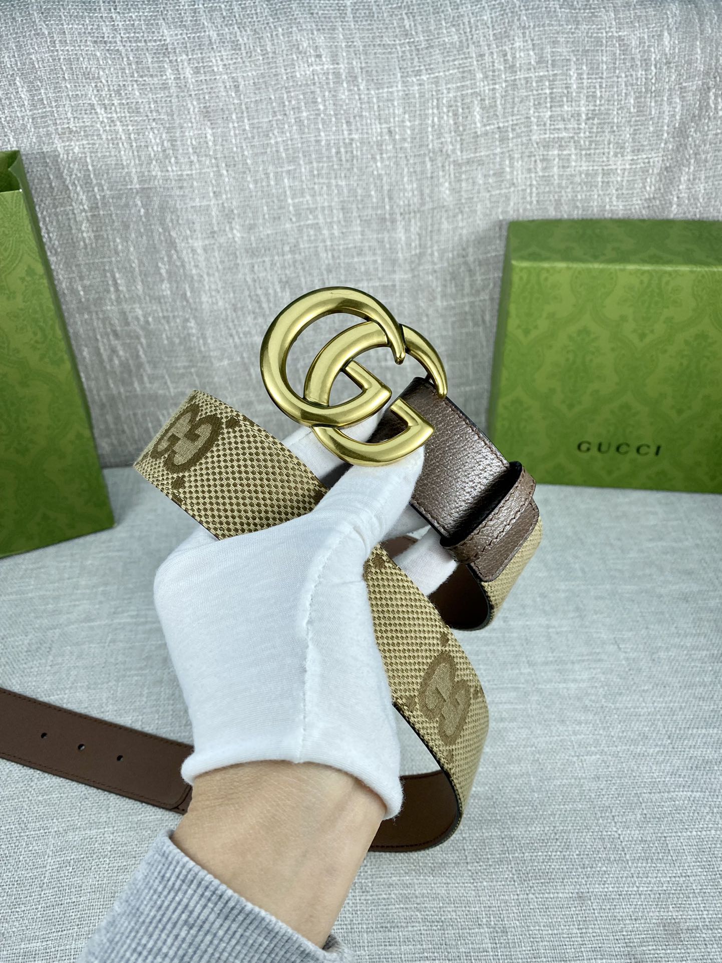 Gucci belt with dark brown leather strap, gold double-G buckle, beige GG panel