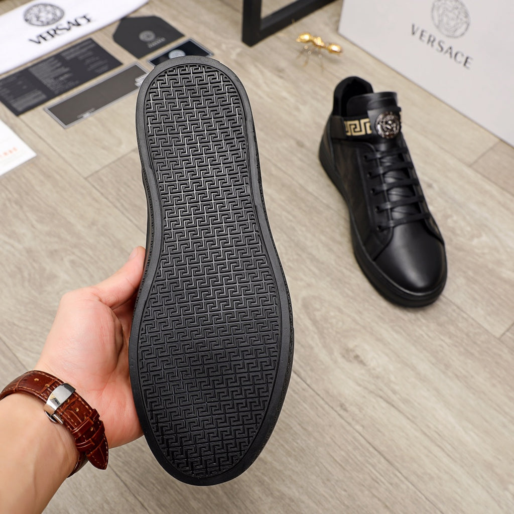 Black Versace sneakers with textured rubber sole underside and side view