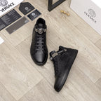 Black Versace leather sneakers with lace-up front and logo strap; pair view