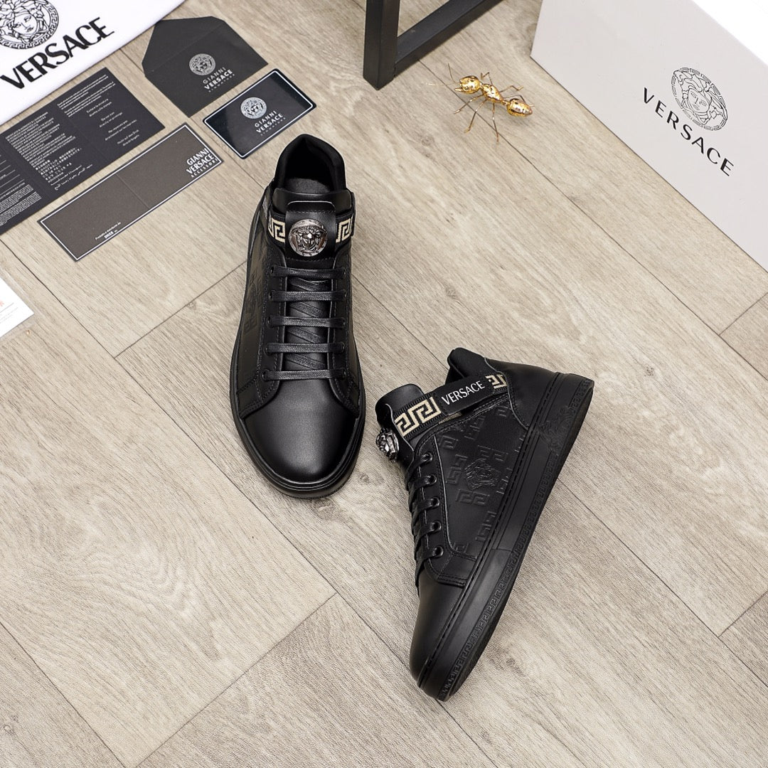 Black Versace leather sneakers with lace-up front and logo strap; pair view