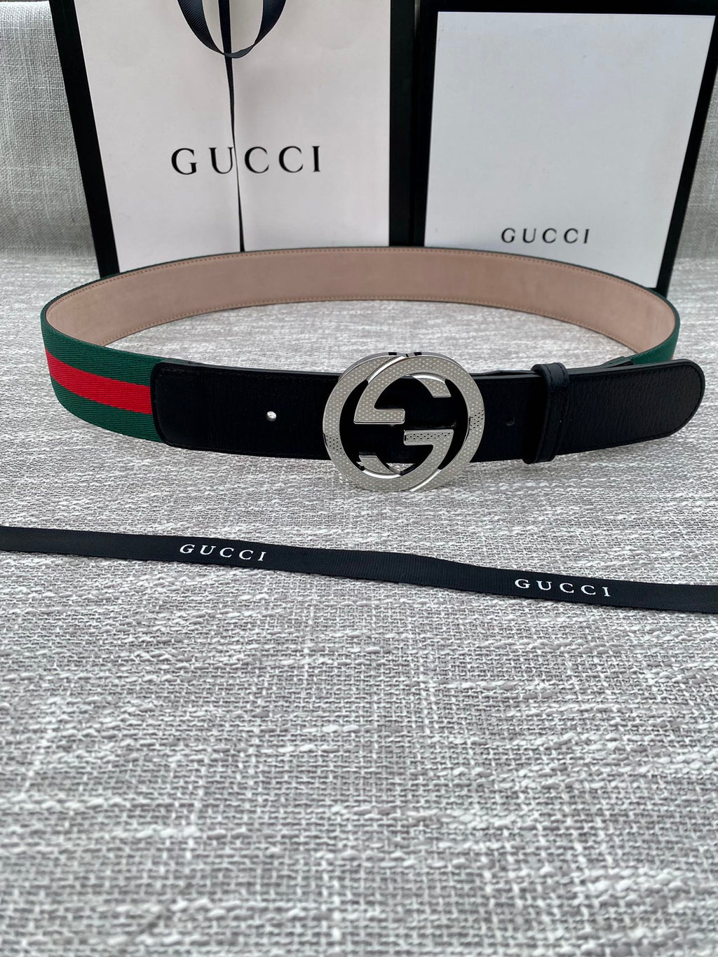 Leather belt with black strap, silver GG buckle, green and red web stripe trim