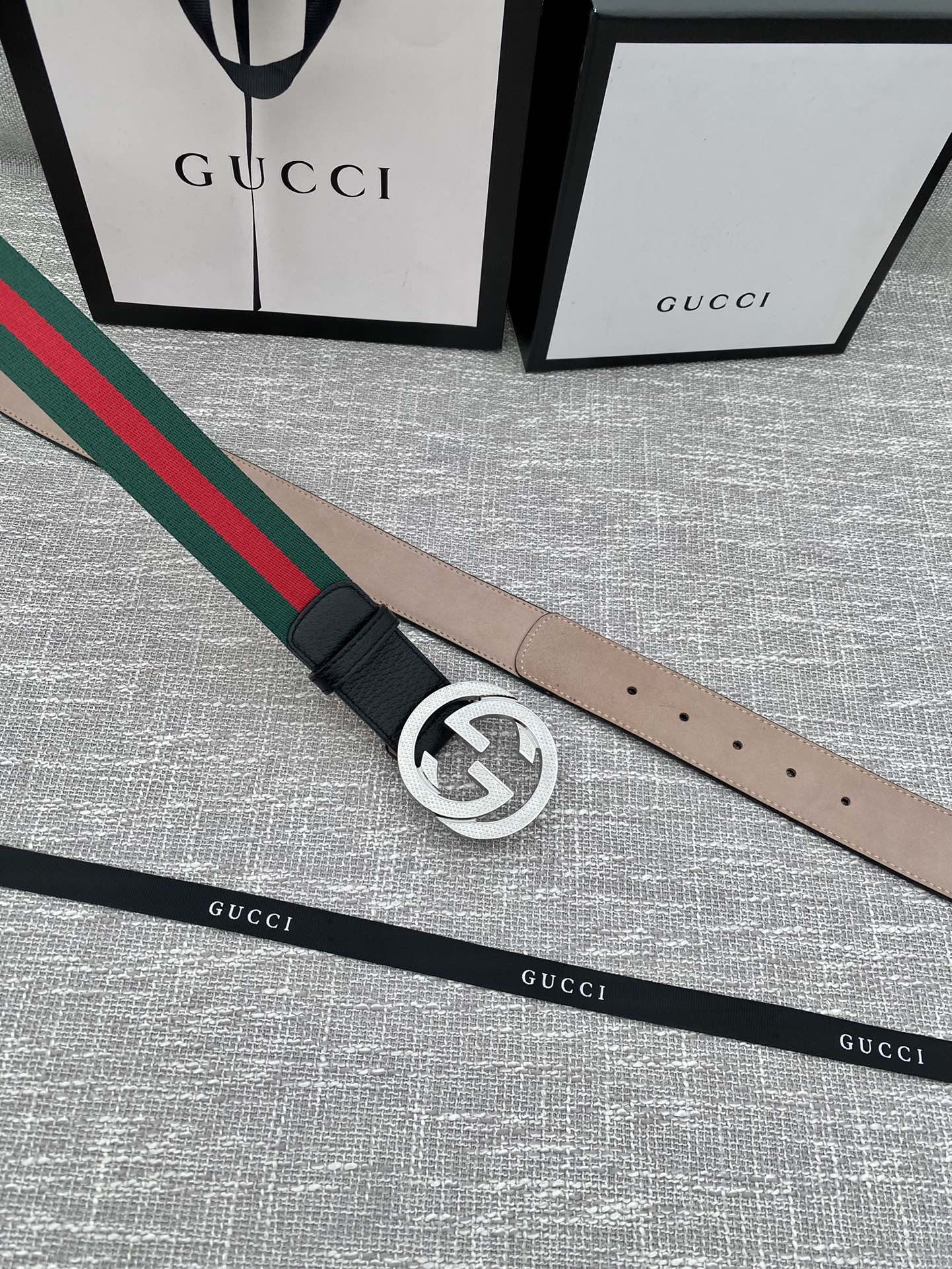 Black leather belt with silver GG buckle and green-red web stripe edge