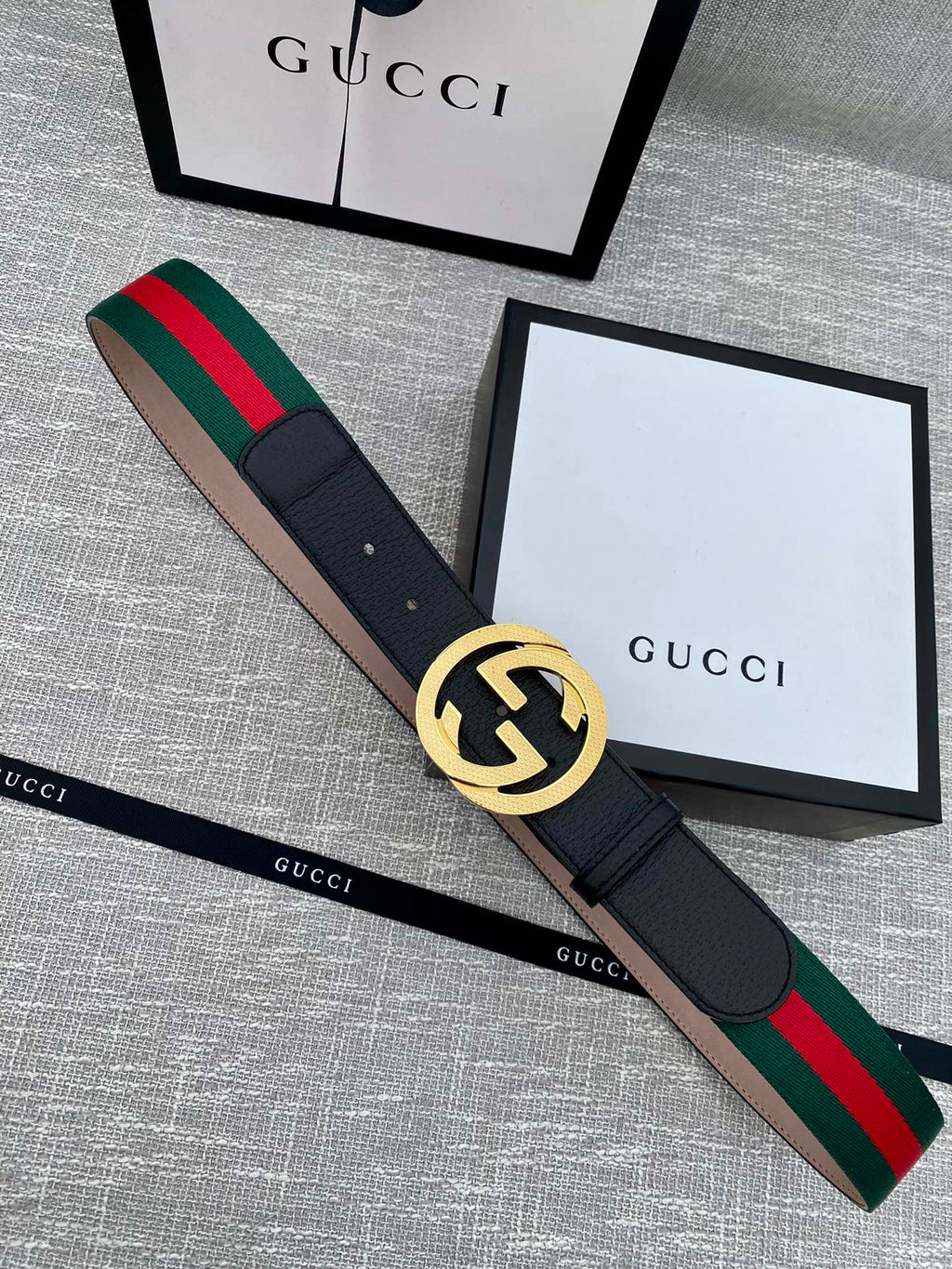 Black leather belt with gold GG buckle and green-red web stripe trim
