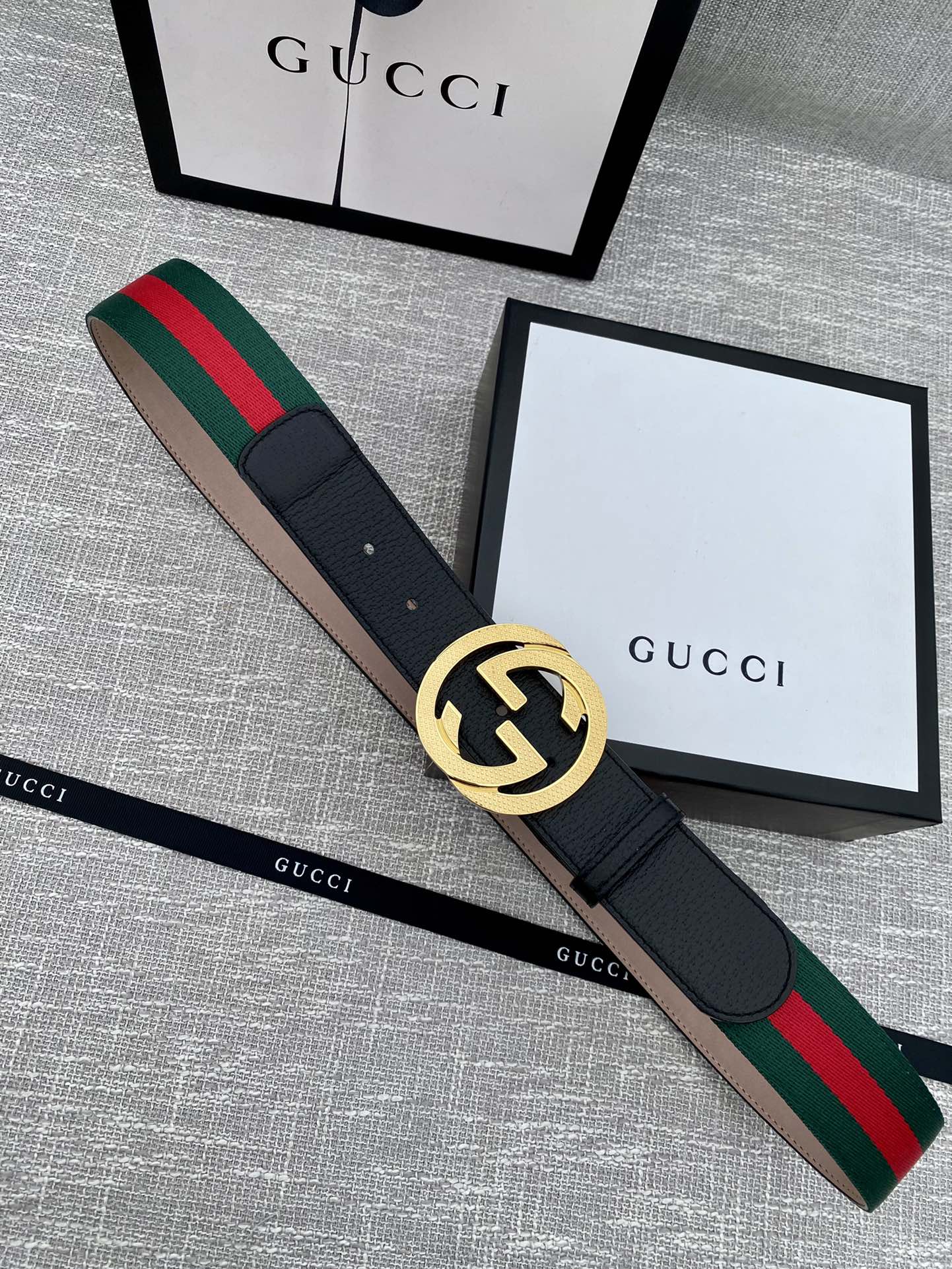 Black leather belt with gold GG buckle and green-red web stripe trim