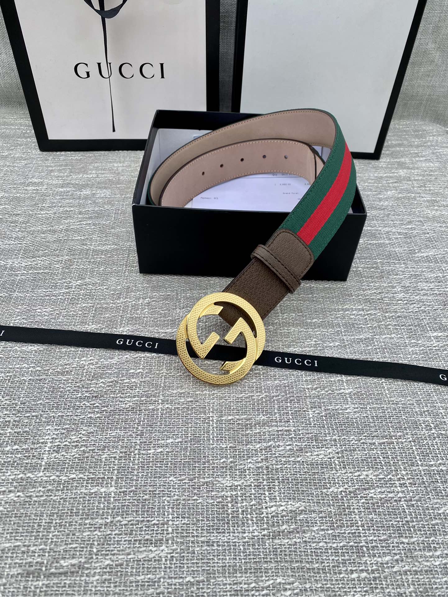 Brown leather Gucci belt with gold-tone GG buckle and green/red web stripe, in box