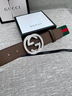 Brown leather belt with silver-tone GG buckle and green/red web stripe, on box