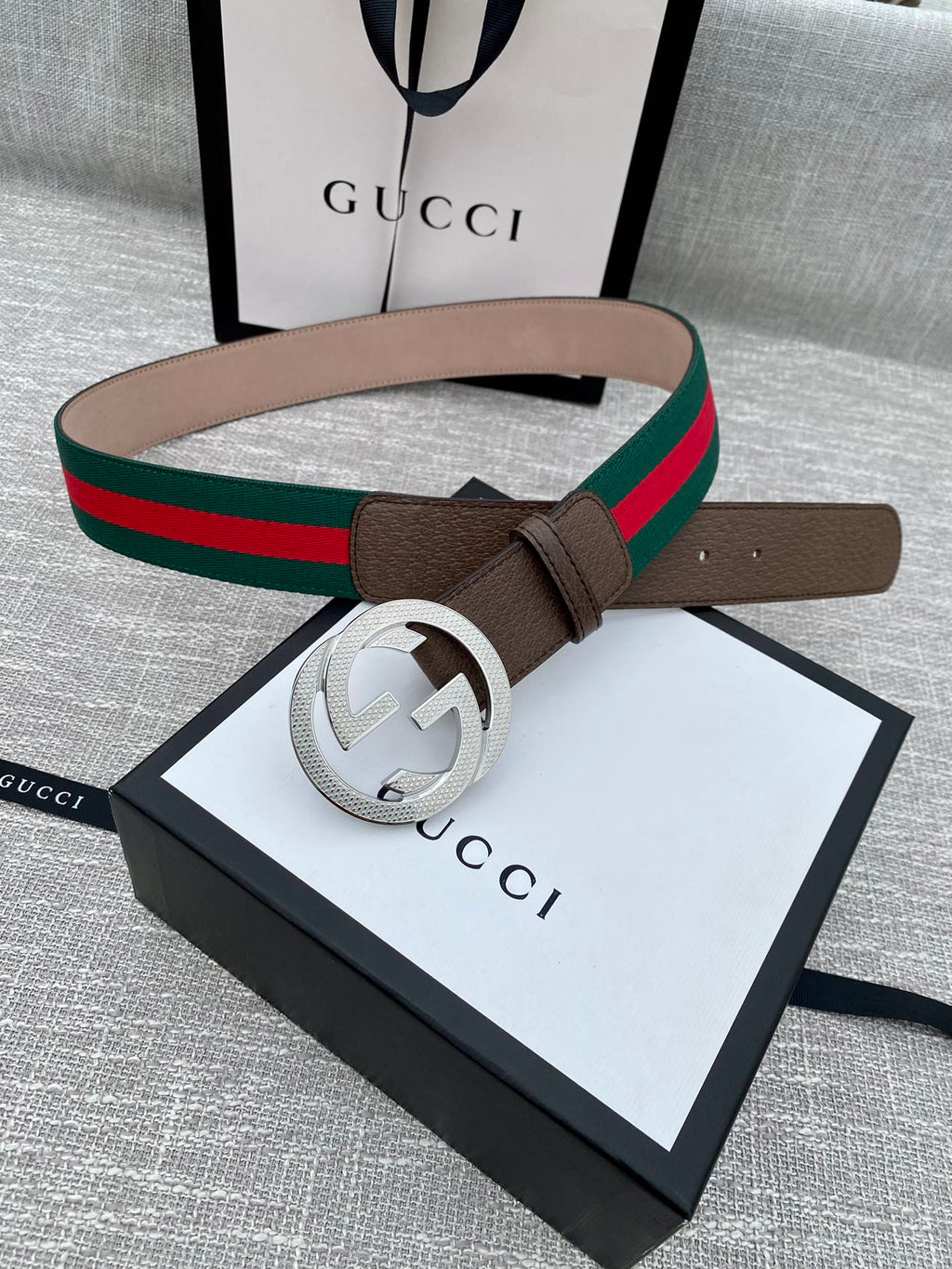 Gucci belt with brown leather, gold-tone GG buckle, and green/red web stripe on box