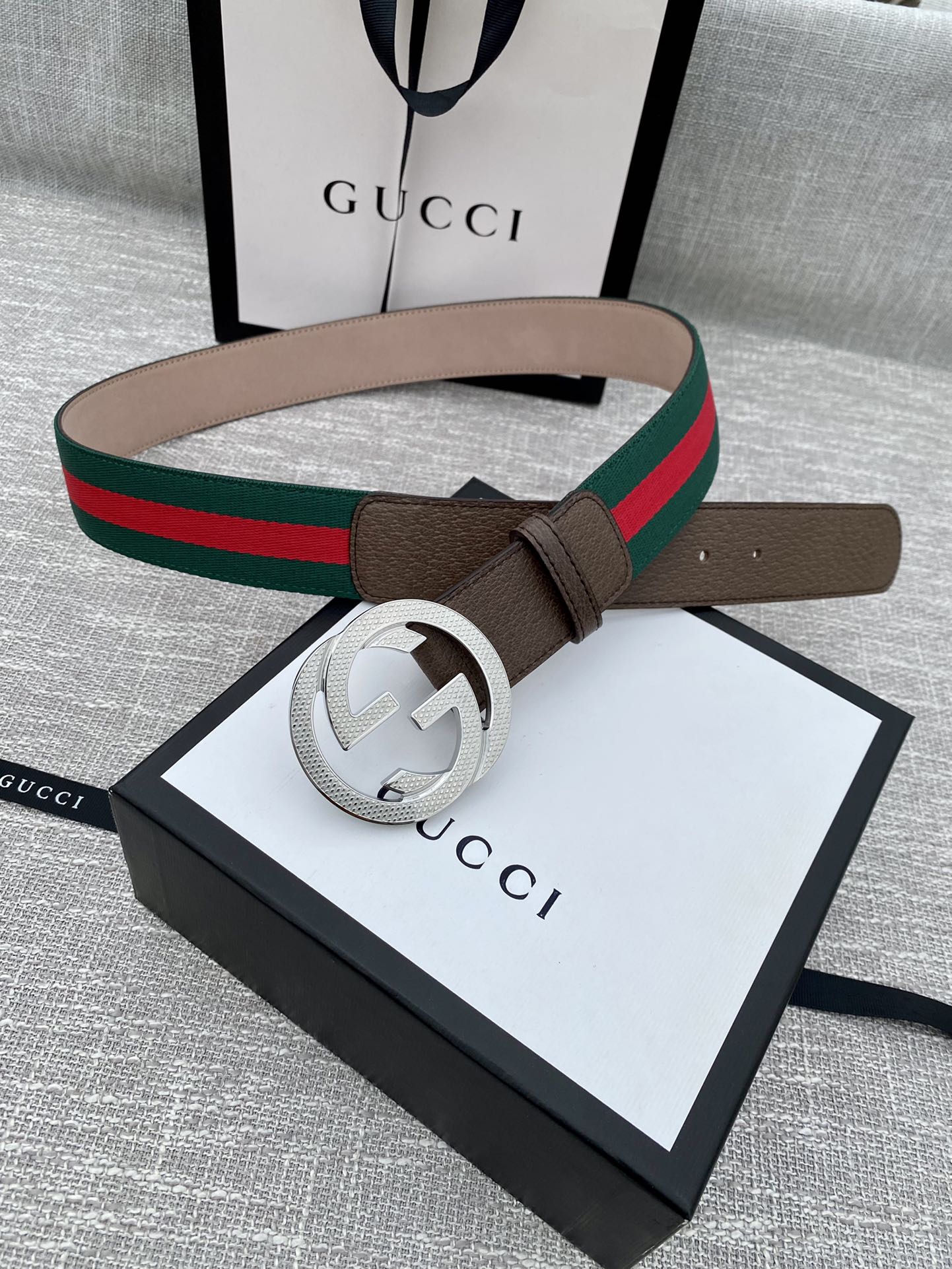 Gucci belt with brown leather, gold-tone GG buckle, and green/red web stripe on box