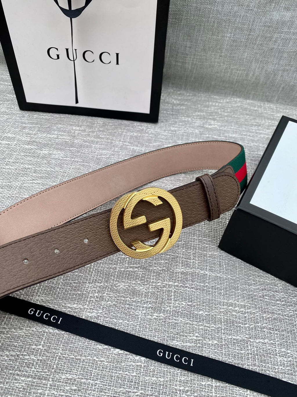 Brown leather belt with gold-tone GG buckle and green/red edge web stripe detail