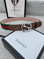 Gucci belt with brown leather strap, silver-tone double G buckle, and green-red stripe web trim.