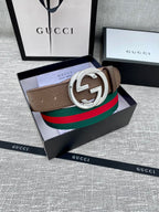 Gucci belt featuring brown leather strap, silver double G buckle, and green-red web stripe.