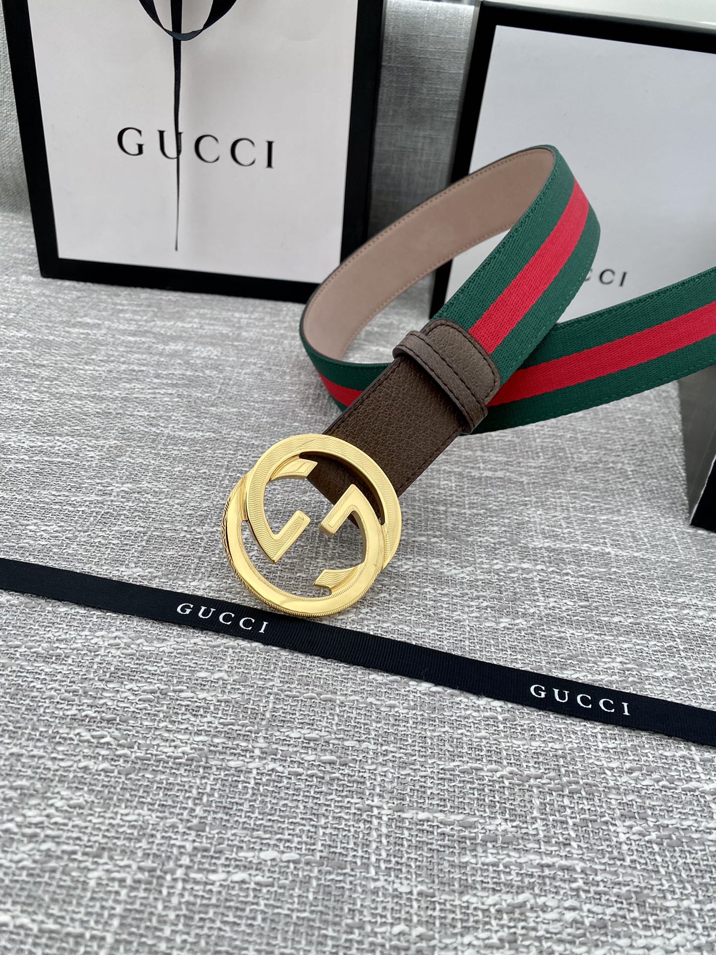 Gucci belt with brown leather strap and gold-tone double G buckle, set with green-red web stripe.