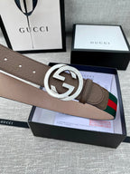 Gucci belt on brown leather with silver double G buckle and green-red web stripe detail.