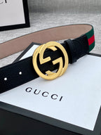 Black leather belt with gold-tone GG buckle and green-red web stripe detail