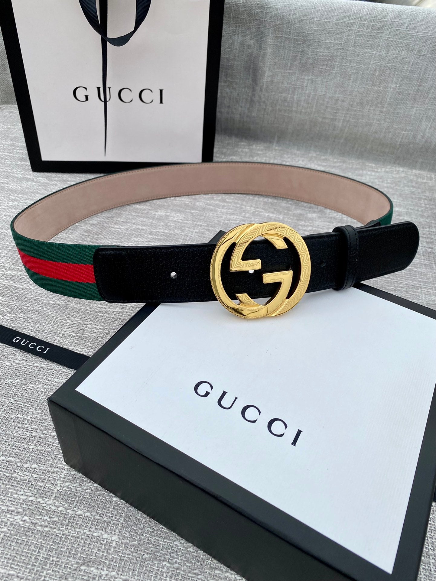 Black leather belt with gold-tone GG buckle and multicolor green-red web stripe