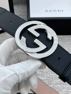 Black leather belt with silver-tone GG buckle close-up on strap