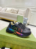 Black Gucci low-top sneakers with multicolor web stripe and textured logo detail