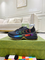 Black Gucci low-top sneakers with multicolor logo print and rubber outsole