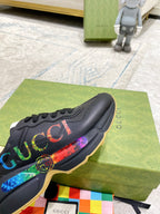 Black Gucci low-top sneaker with multicolor web logo stripe and round emblem