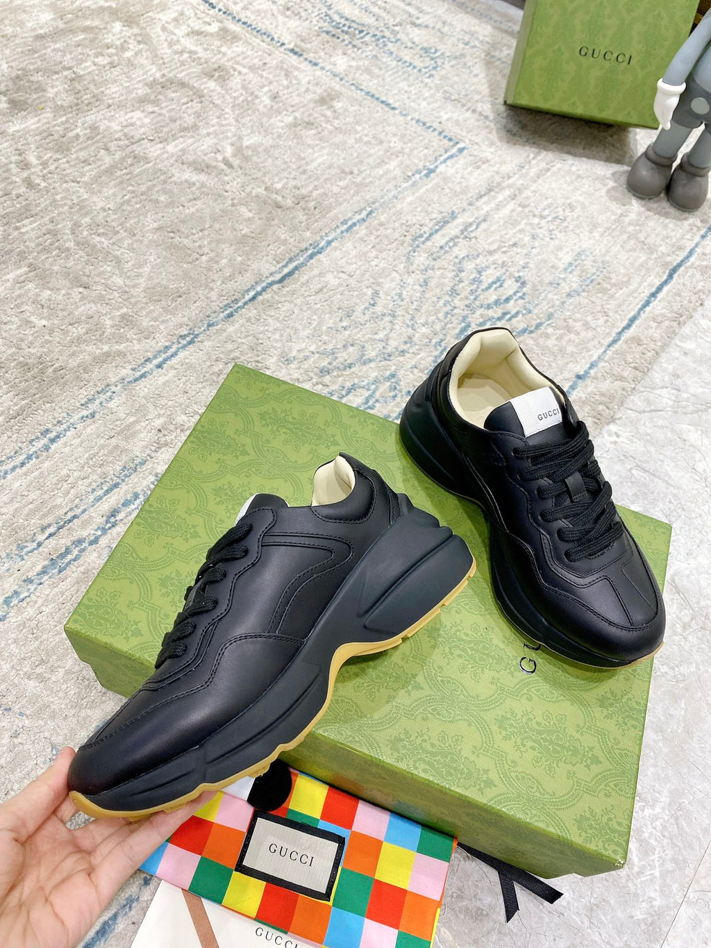 Black Gucci low-top sneakers with smooth toe cap and lace-up design