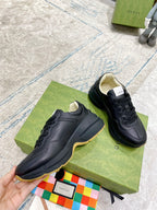 Black Gucci low-top sneakers with smooth toe cap and lace-up design
