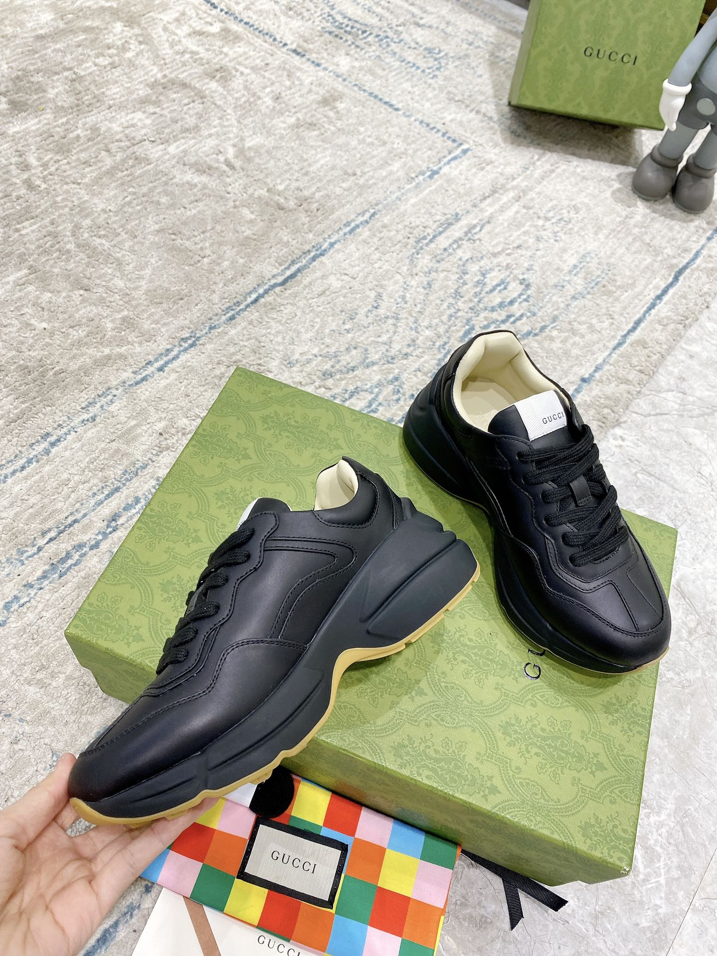 Black Gucci low-top sneakers with smooth toe cap and lace-up design
