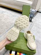 White sneaker sole and side profile on green box; tread and “GUCCI” branding.