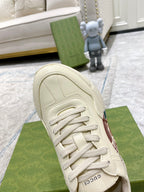White sneaker upper close-up with laces and stitched toe panel.