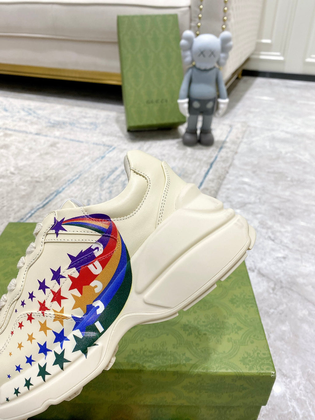 Close-up of white sneaker with star-and-flag graphic on side, lace-up
