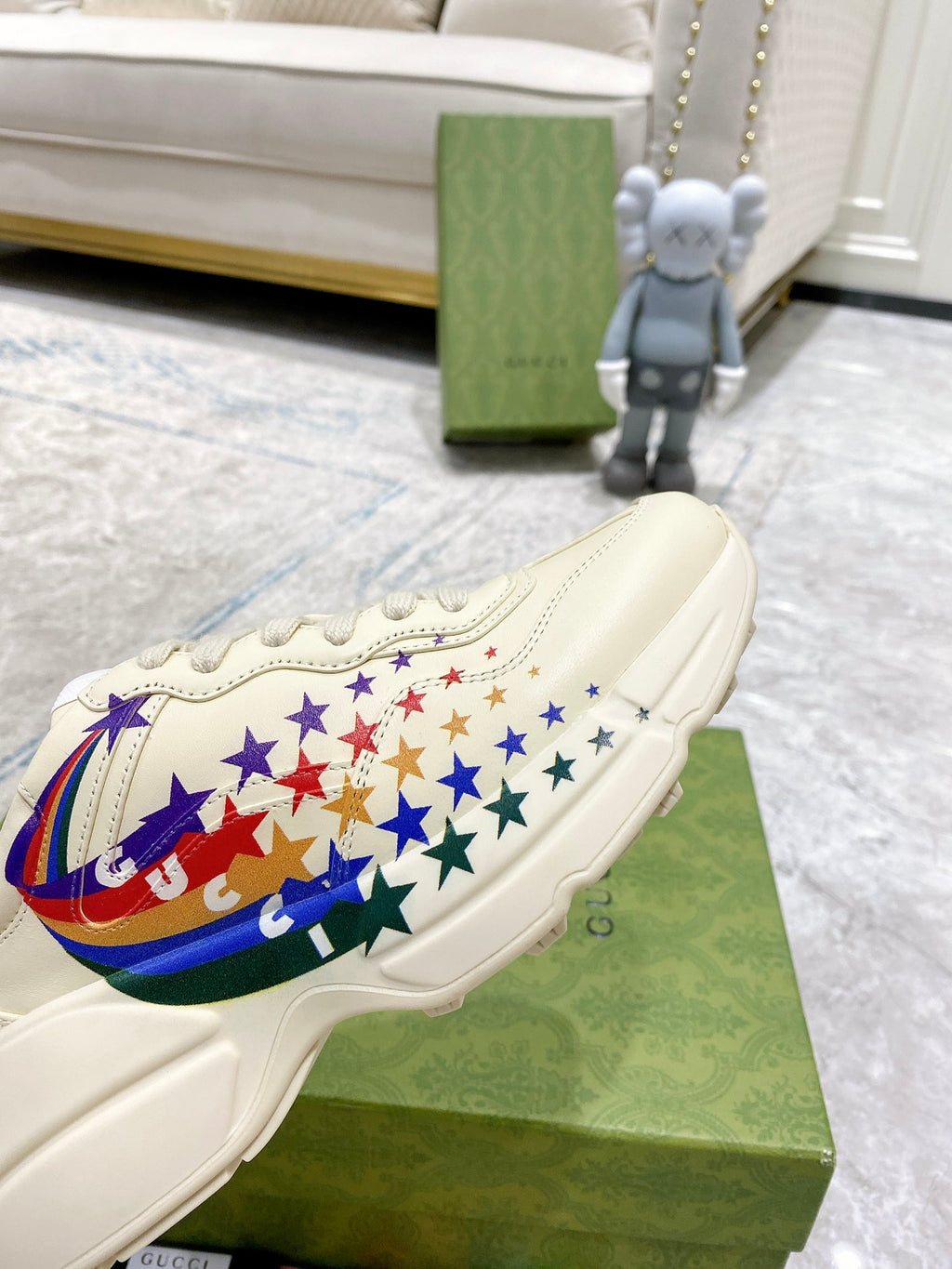 Close-up of white sneaker with multicolor star and flag graphic on side