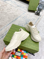 White Gucci unisex lace-up sneakers on green box