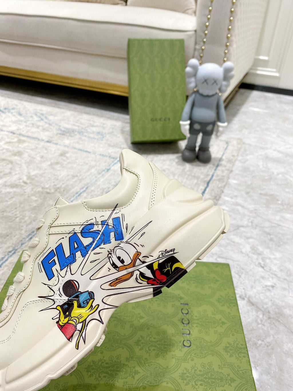 White Gucci unisex sneaker with 'FLASH' comic graphic near toe
