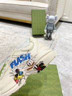 White Gucci unisex sneaker with 'FLASH' comic graphic near toe