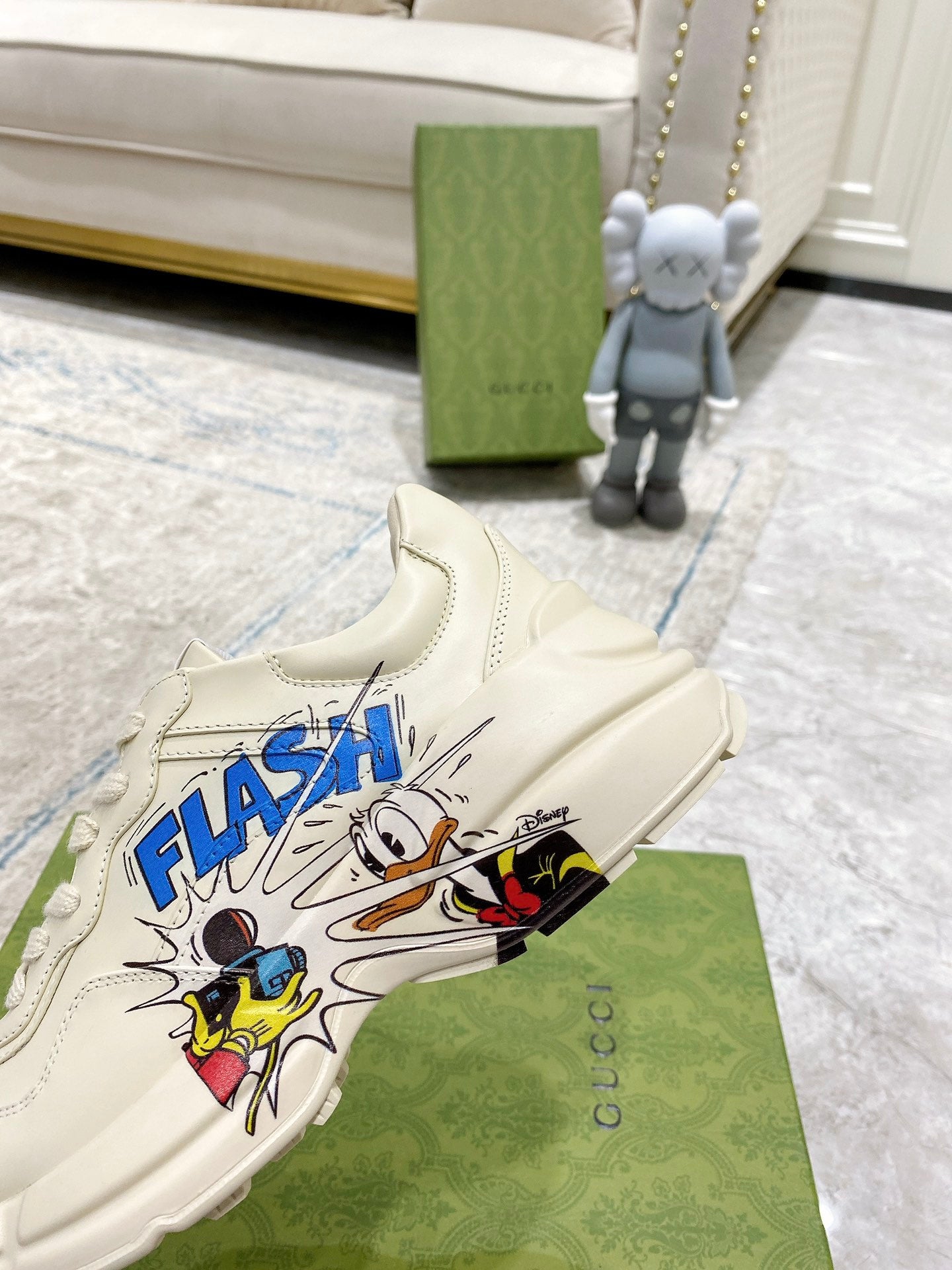 White Gucci unisex sneaker with 'FLASH' comic graphic near toe