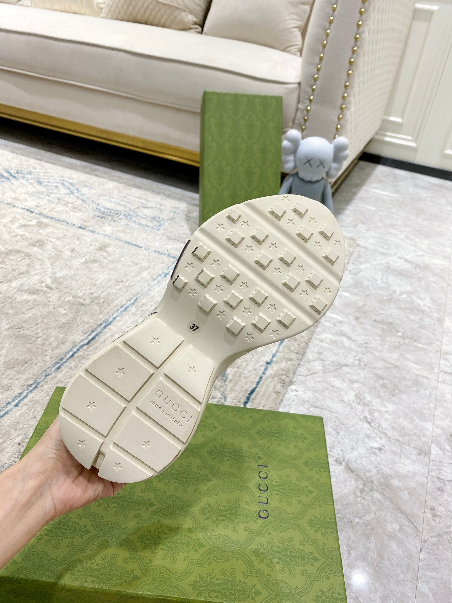 White Gucci unisex sneaker outsole view with traction tread and Gucci logo